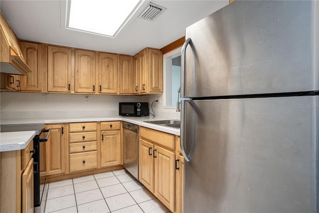 kitchen featuring light tile patterned floors, visible vents, light countertops, decorative backsplash, and black appliances