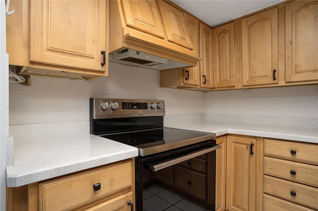 kitchen with tasteful backsplash, light countertops, and stainless steel range with electric cooktop