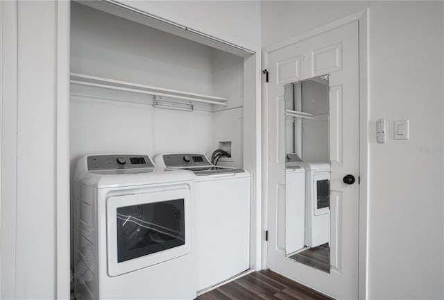 washroom featuring laundry area, dark wood-type flooring, and washer and clothes dryer