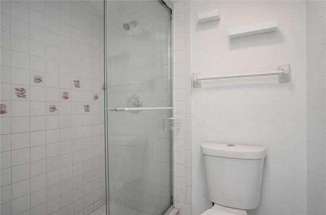 bathroom with toilet and a stall shower