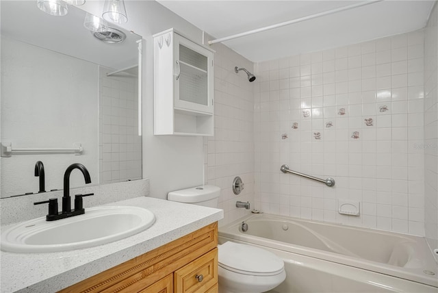 full bathroom featuring bathtub / shower combination, vanity, and toilet