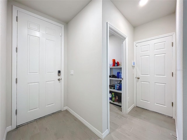 entryway featuring light wood-style flooring and baseboards