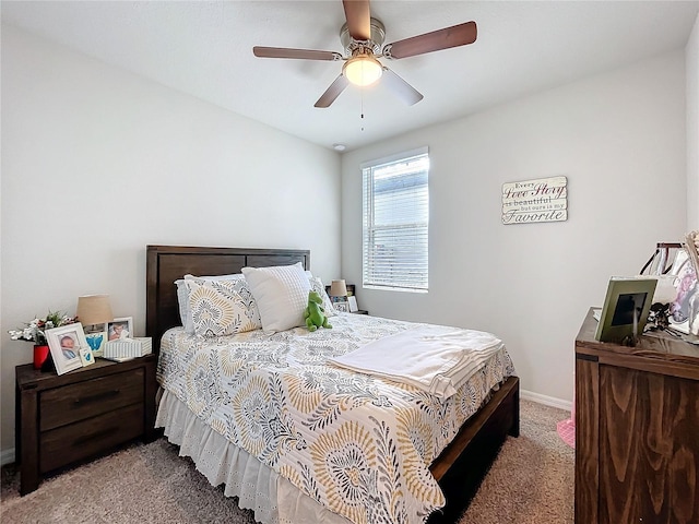 bedroom with ceiling fan, carpet, and baseboards