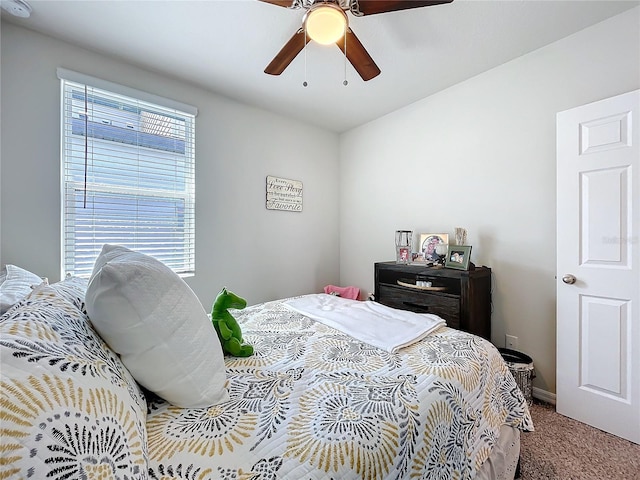 bedroom with a ceiling fan and carpet