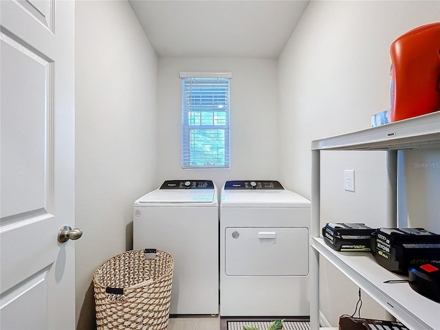 clothes washing area featuring laundry area and washing machine and clothes dryer