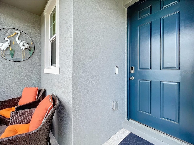 property entrance featuring stucco siding