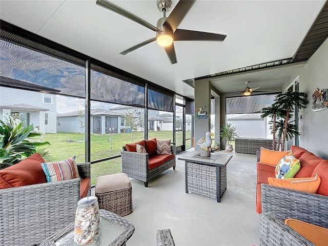 sunroom / solarium featuring a ceiling fan