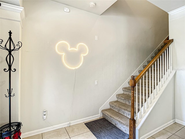 stairs featuring baseboards and tile patterned floors