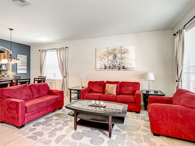 tiled living room featuring visible vents