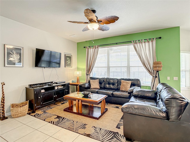 living area with ceiling fan and light tile patterned floors