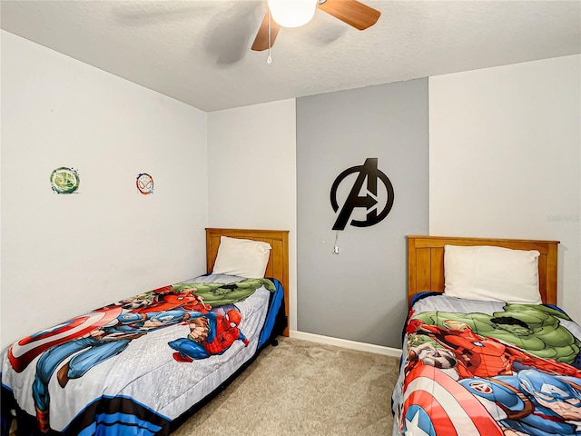 bedroom featuring baseboards, ceiling fan, a textured ceiling, and light colored carpet