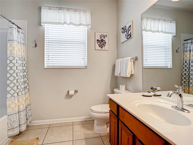 bathroom featuring toilet, baseboards, a wealth of natural light, and tile patterned floors