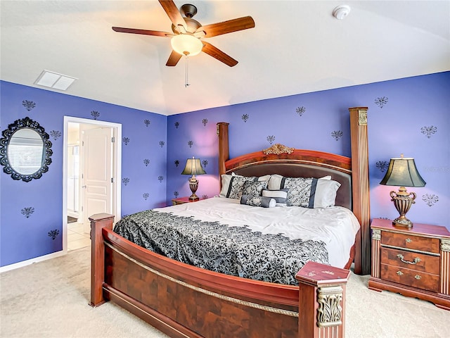 bedroom with lofted ceiling, ceiling fan, ensuite bathroom, carpet flooring, and visible vents