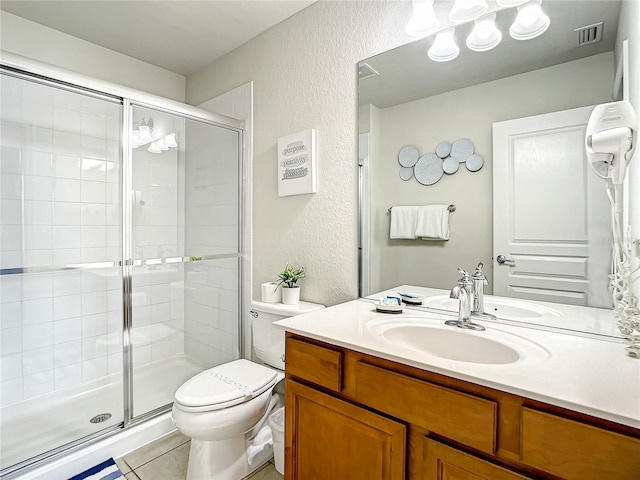 bathroom featuring visible vents, a textured wall, a shower stall, and toilet