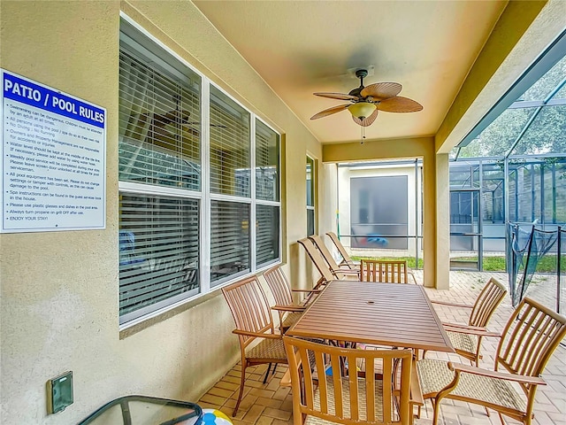 sunroom / solarium featuring a ceiling fan and plenty of natural light