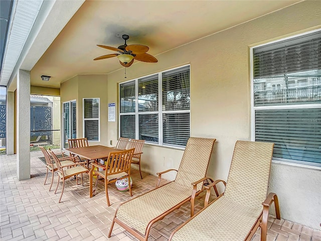 view of patio / terrace with outdoor dining area and a ceiling fan