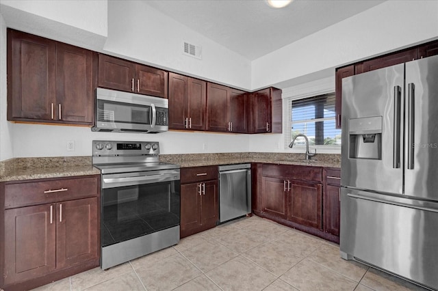 kitchen featuring light tile patterned floors, visible vents, stainless steel appliances, and a sink