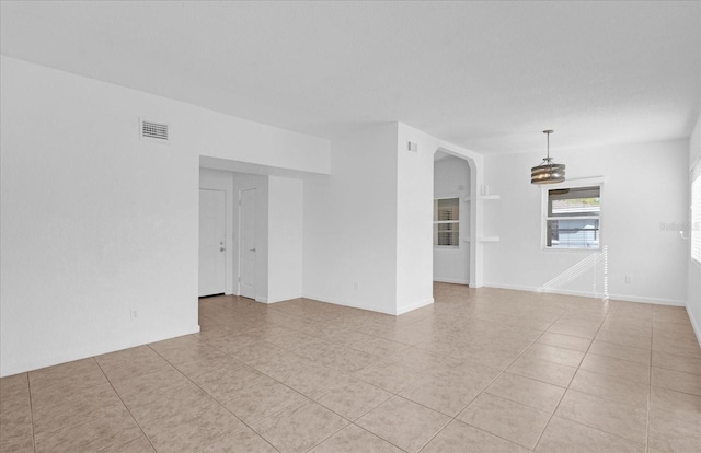 unfurnished room with light tile patterned floors and visible vents