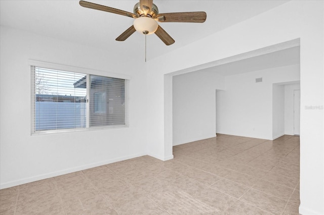 spare room with visible vents, baseboards, and ceiling fan