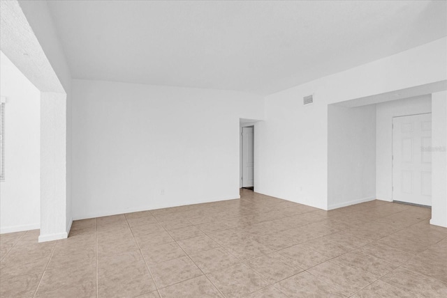 unfurnished room with visible vents