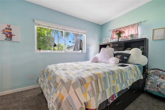 bedroom with baseboards, carpet flooring, and a textured wall