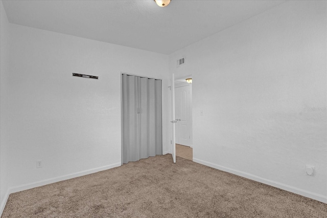 empty room with baseboards, carpet floors, and visible vents