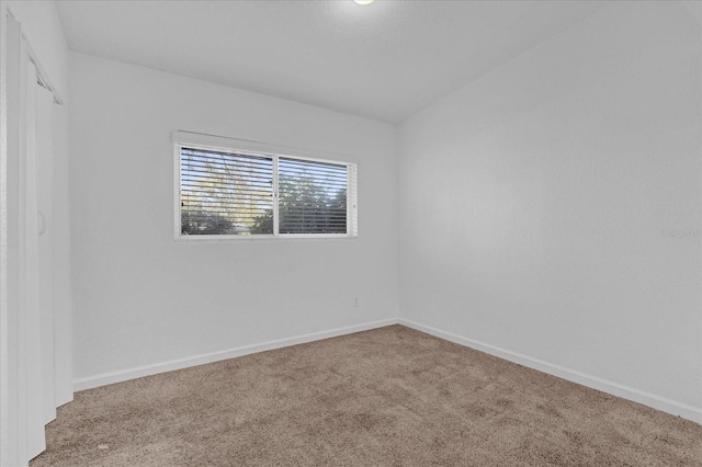 empty room with carpet flooring and baseboards