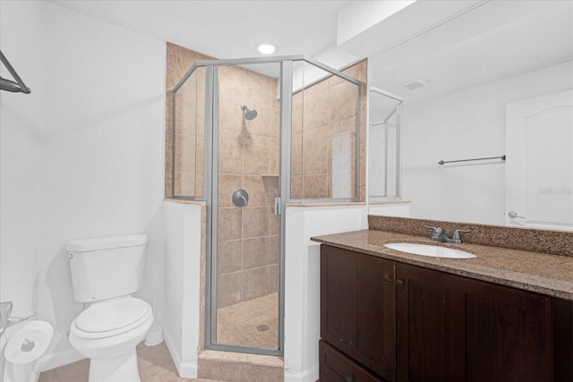 bathroom featuring visible vents, a shower stall, toilet, and vanity