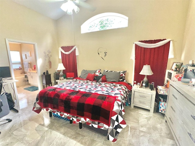 bedroom with marble finish floor, a high ceiling, and connected bathroom