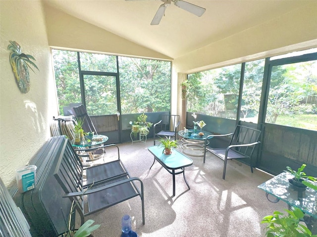 sunroom / solarium with a healthy amount of sunlight, vaulted ceiling, and ceiling fan