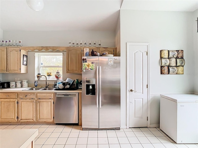 kitchen featuring a sink, stainless steel appliances, light brown cabinetry, and light countertops