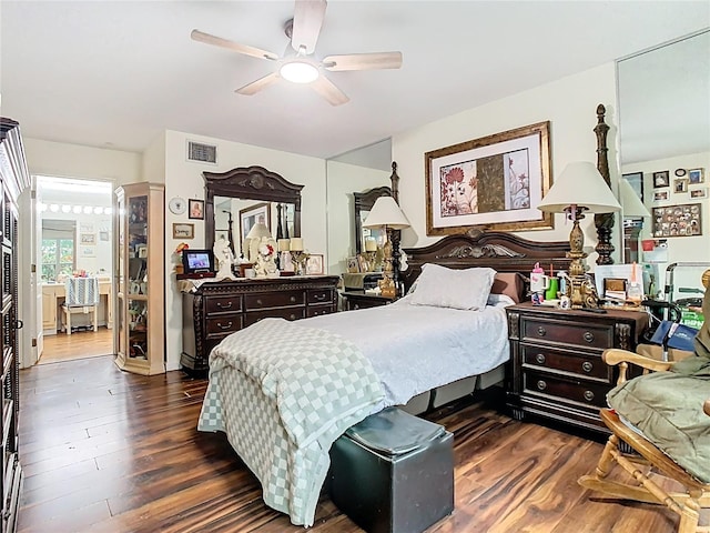 bedroom featuring visible vents, dark wood-type flooring, and ceiling fan