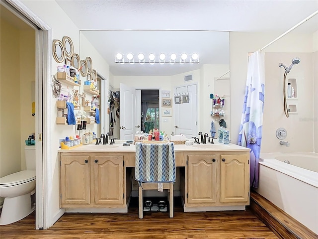 full bath featuring visible vents, wood finished floors, toilet, and shower / bath combo