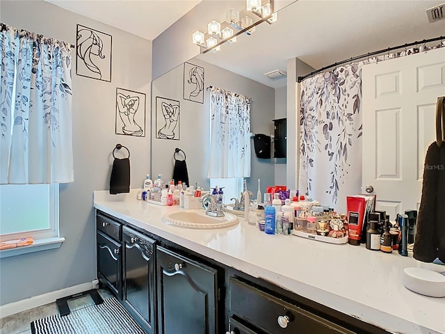 full bathroom featuring visible vents, baseboards, and vanity