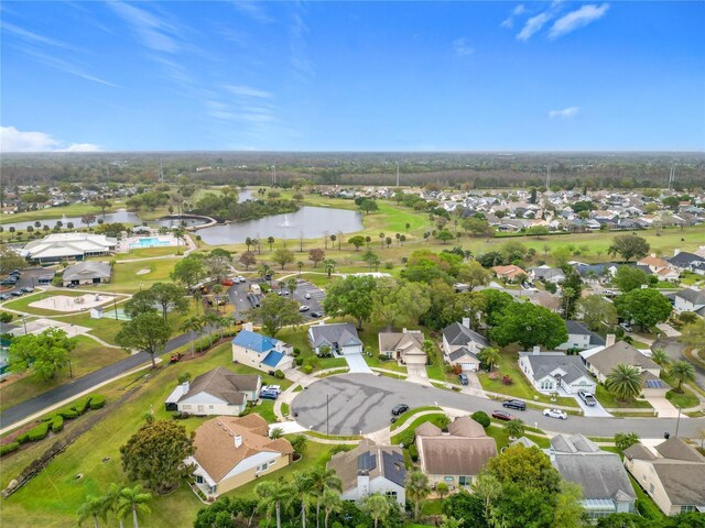 drone / aerial view featuring a residential view and a water view