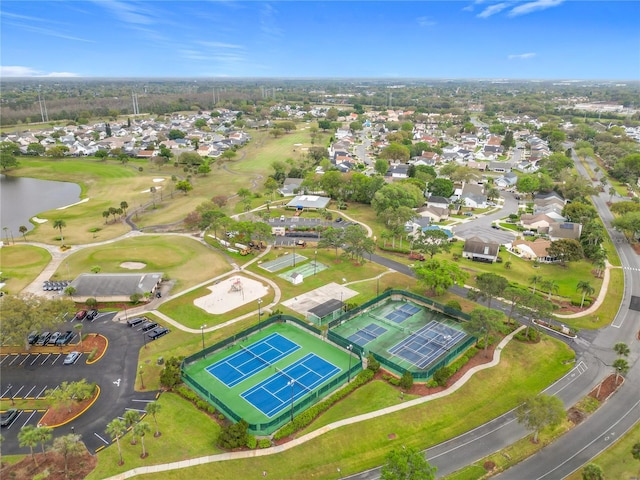 aerial view with a residential view, view of golf course, and a water view