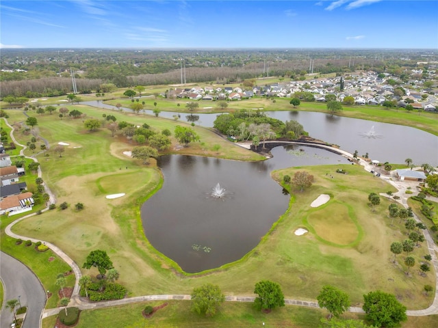 drone / aerial view with a water view and golf course view