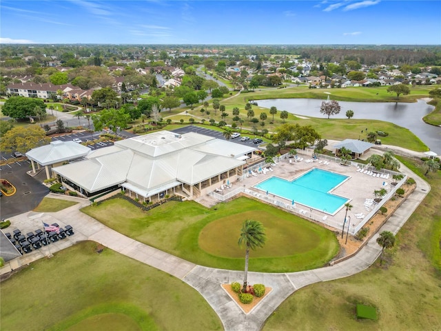 birds eye view of property with a water view and view of golf course