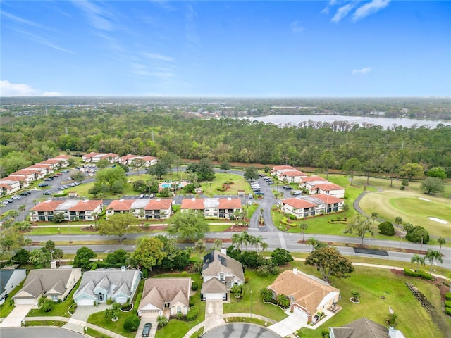 bird's eye view featuring a wooded view, a residential view, and a water view