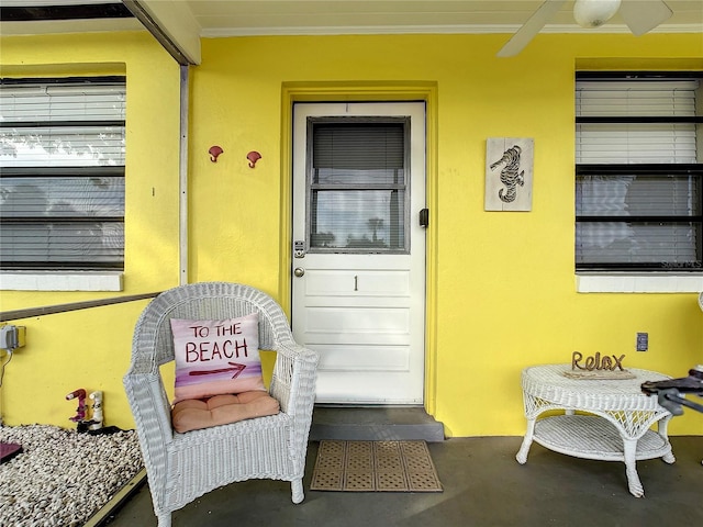 entrance to property featuring stucco siding