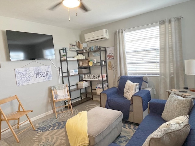 living room featuring baseboards, an AC wall unit, and ceiling fan