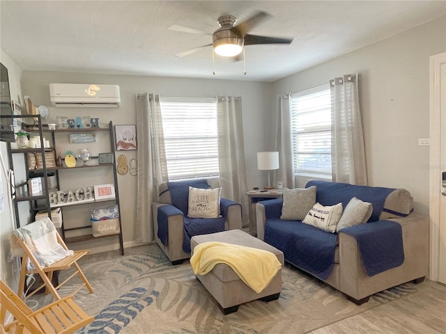 living area featuring an AC wall unit and ceiling fan