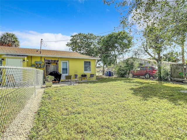 view of yard with a patio and a fenced backyard