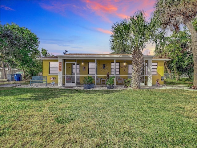 view of front facade featuring stucco siding and a front lawn