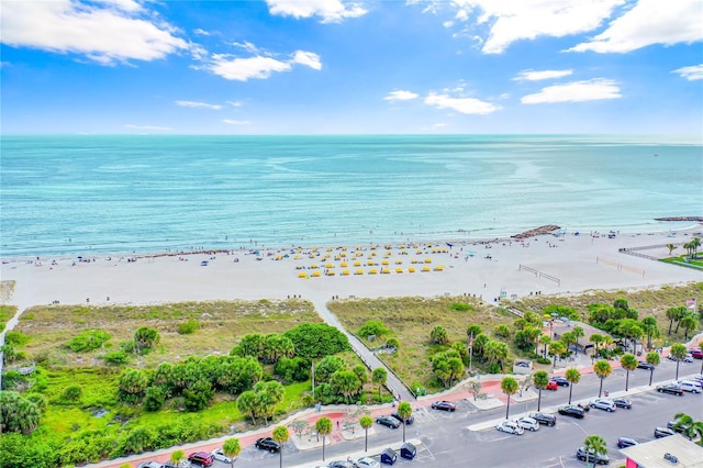 bird's eye view with a water view and a beach view