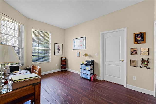 office area with dark wood finished floors and baseboards