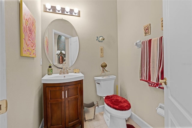 half bath with vanity, toilet, baseboards, and tile patterned flooring