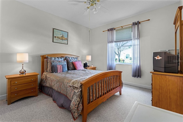 carpeted bedroom with a ceiling fan and baseboards