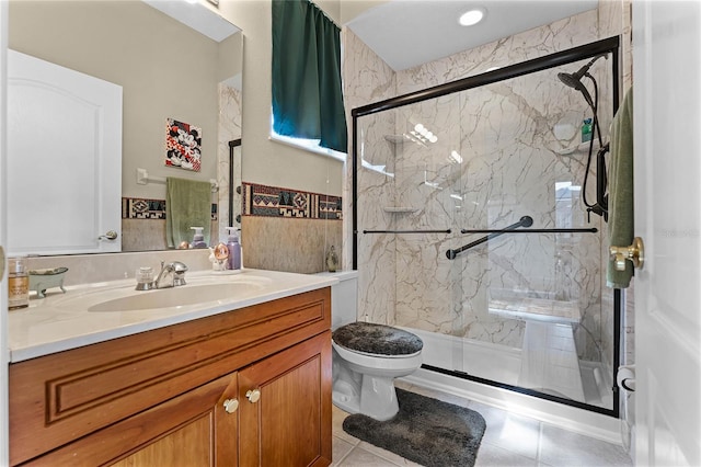 bathroom featuring a marble finish shower, toilet, tile patterned floors, and vanity