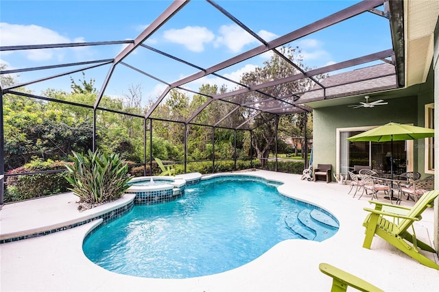 view of swimming pool with a patio, a lanai, a ceiling fan, and a pool with connected hot tub